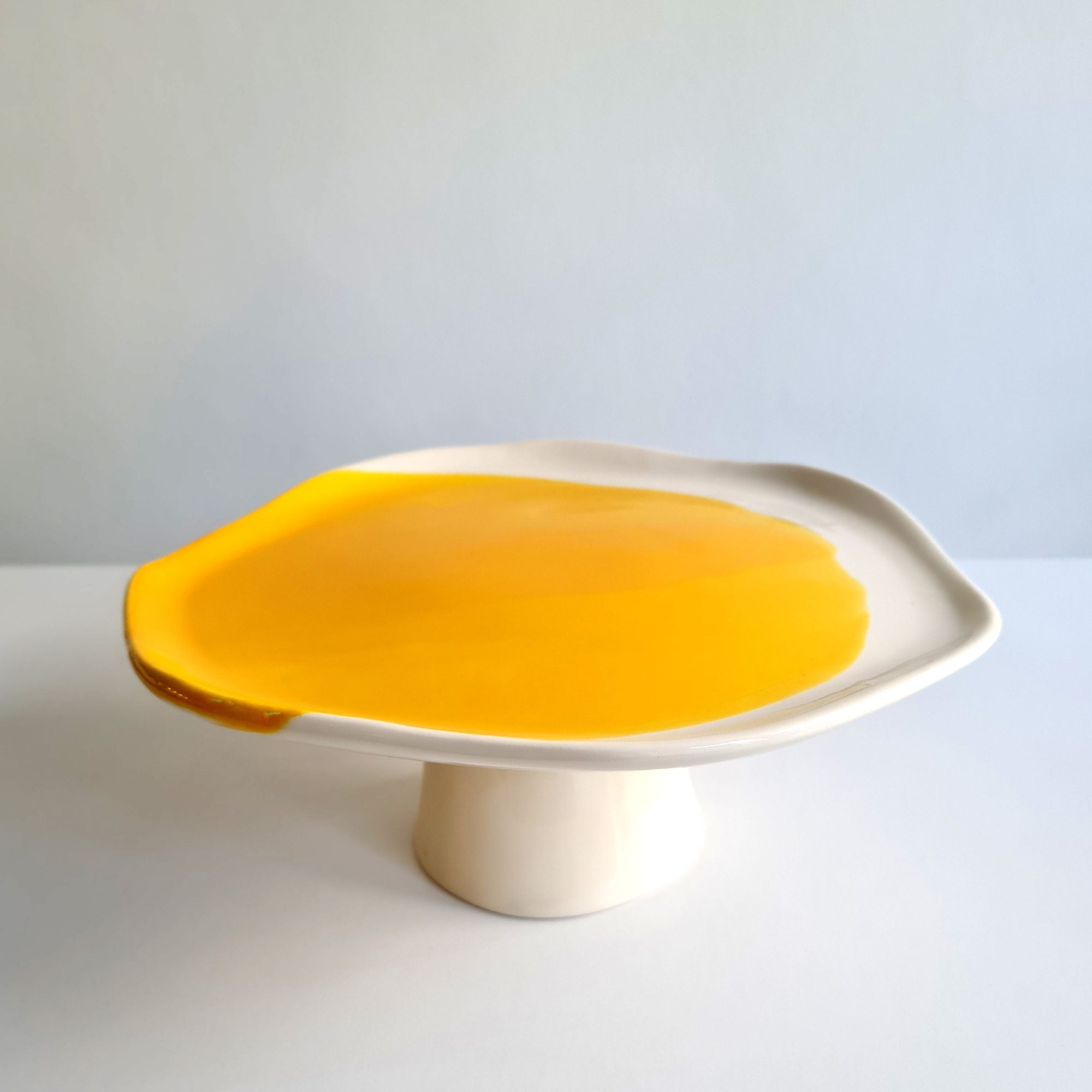 Artistic cake stand in handmade porcelain with a glossy Cadmium Yellow glaze top