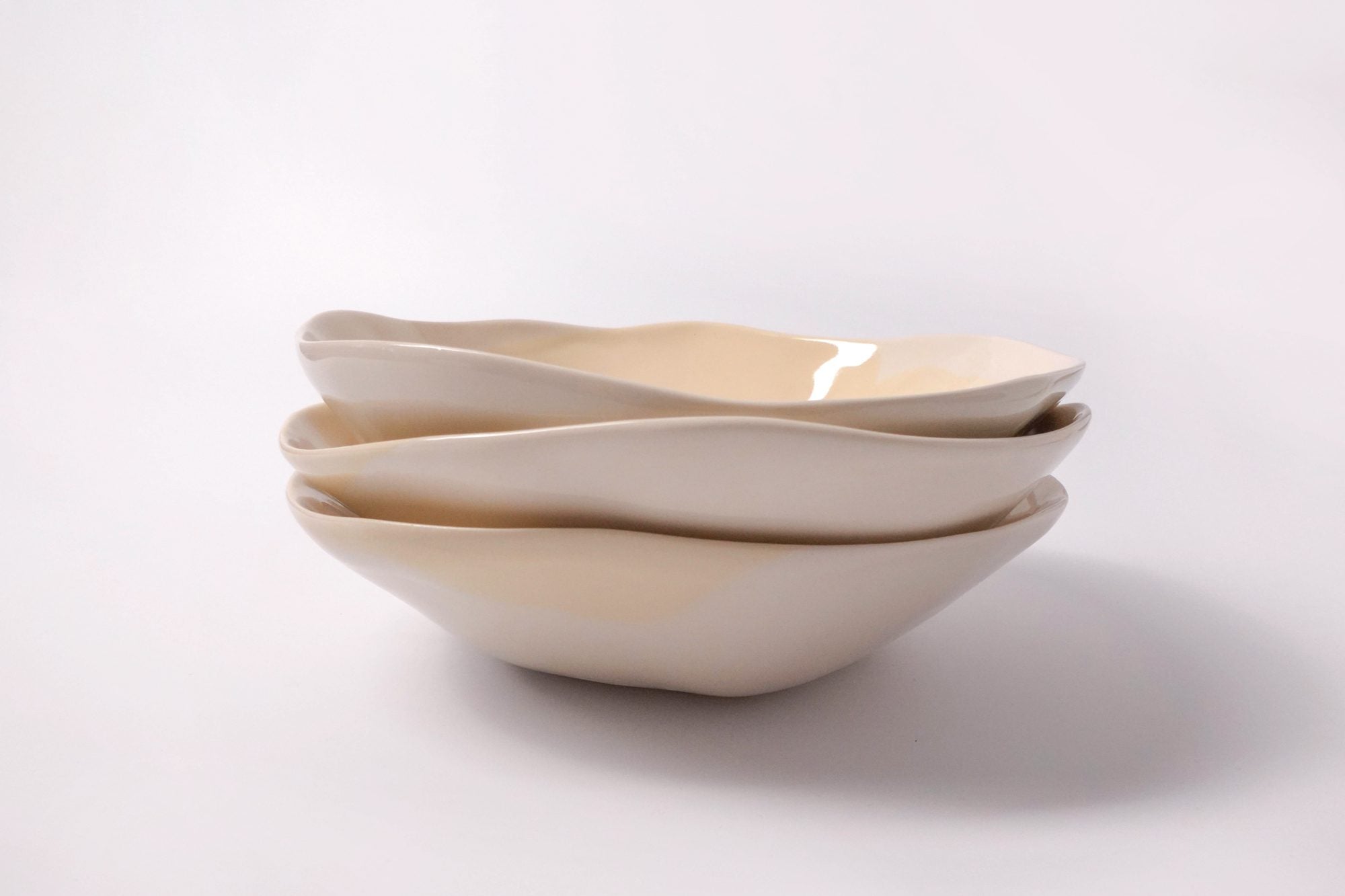 Multi-use porcelain bowl 24 cm in a custom colour, three stacked with wavy rims