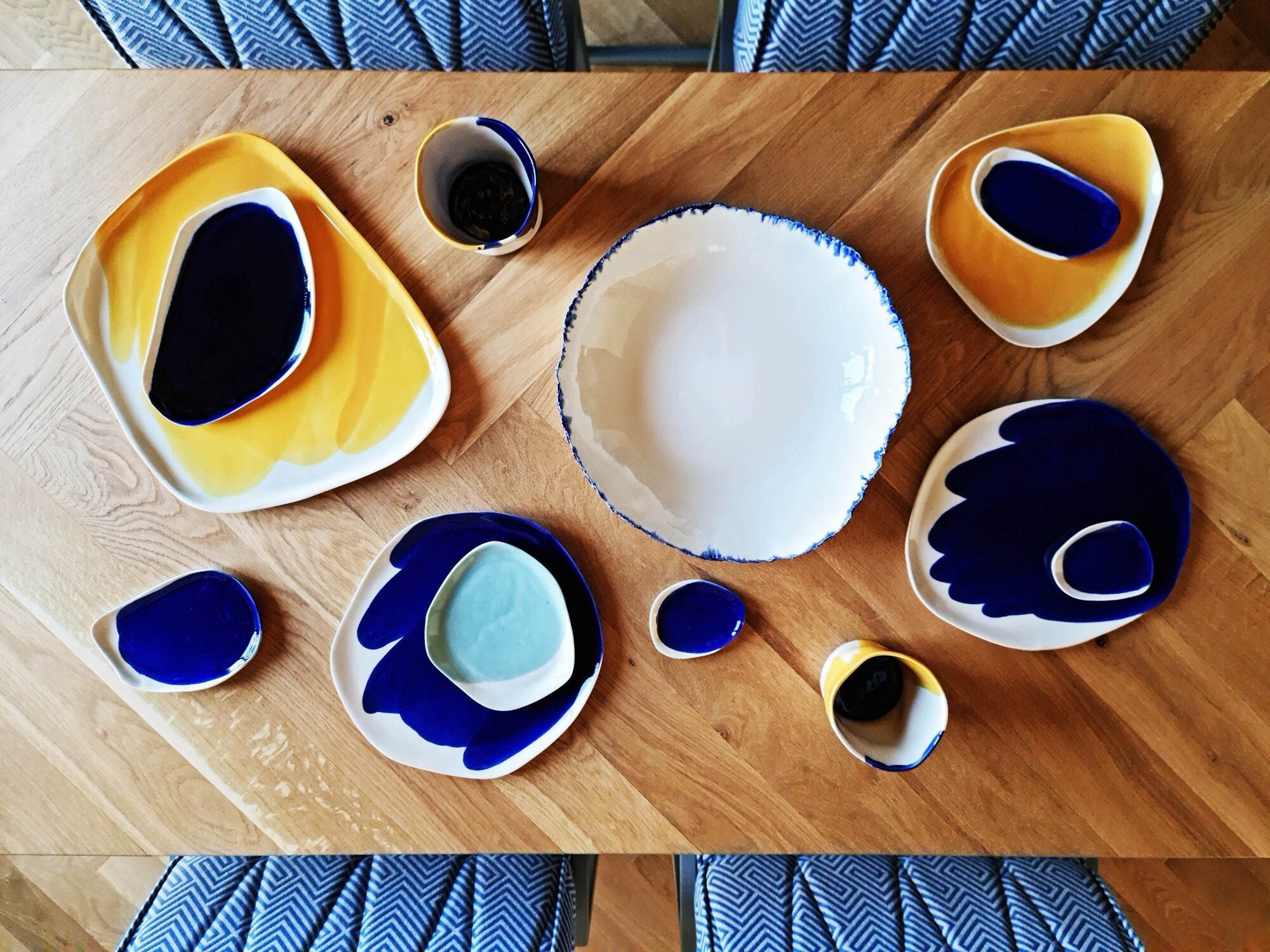 Wooden table set with Royal Blue and yellow glaze handmade porcelain plates and small bowls