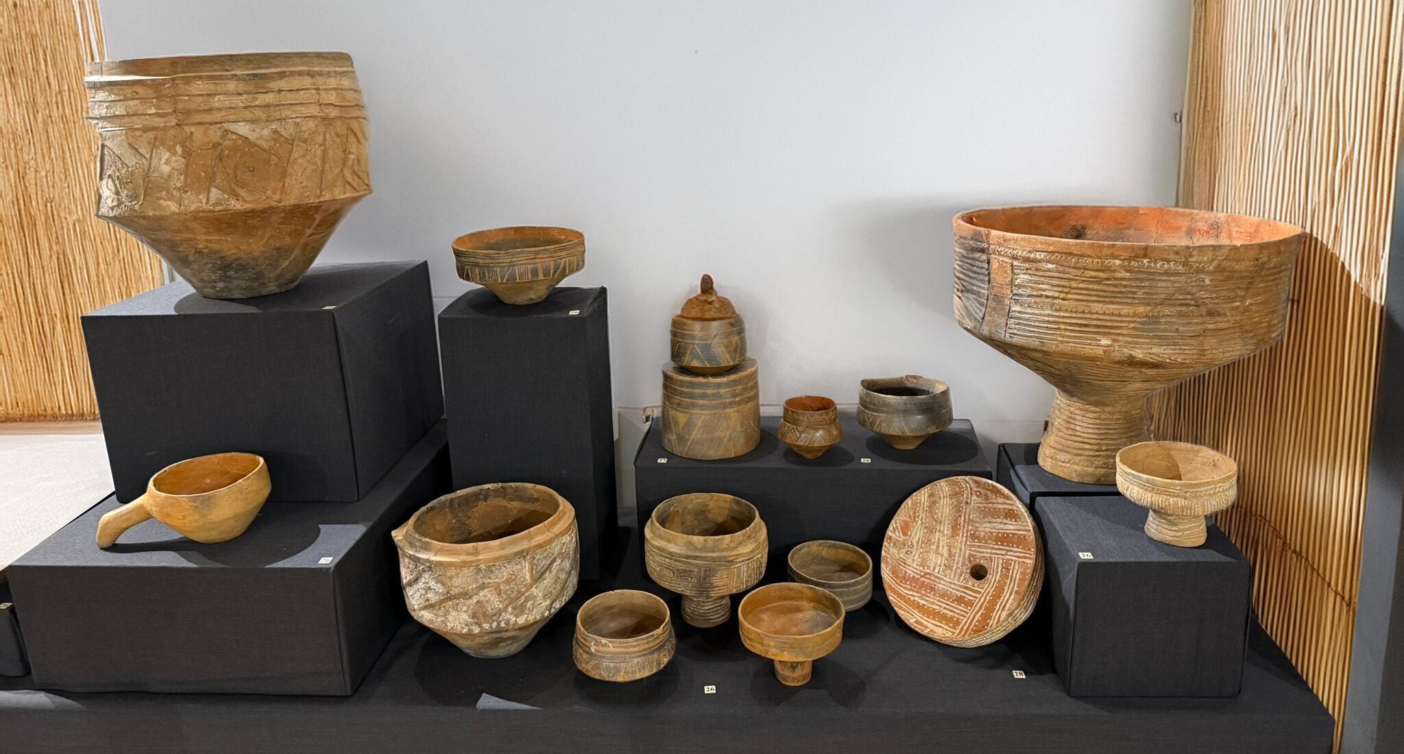 Museum display of ancient Neolithic clay vessels, the origins of the sgraffito technique