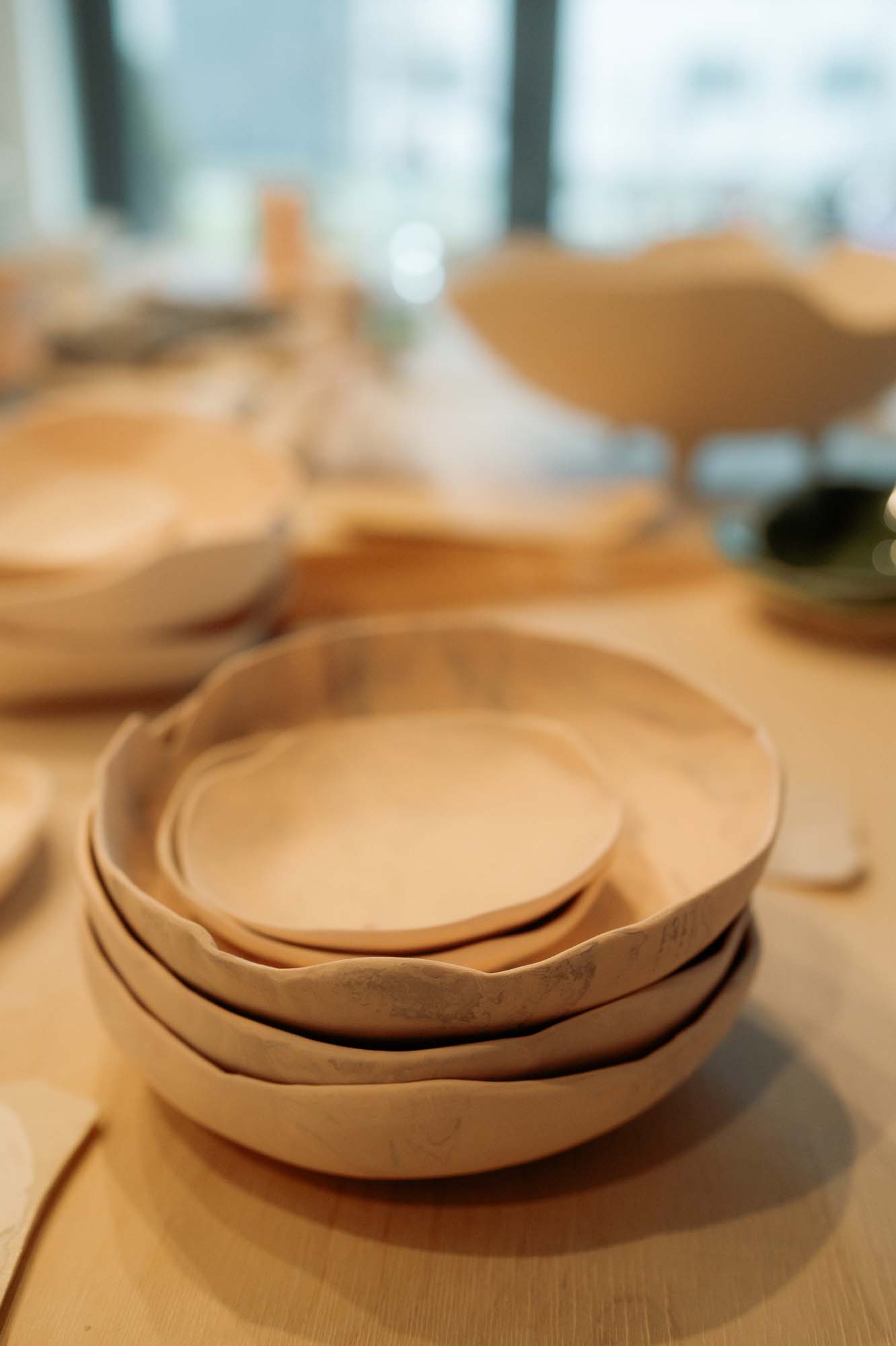 Stack of unglazed handmade ceramic bowls shown at The New Valuable exhibition at Museum Etar