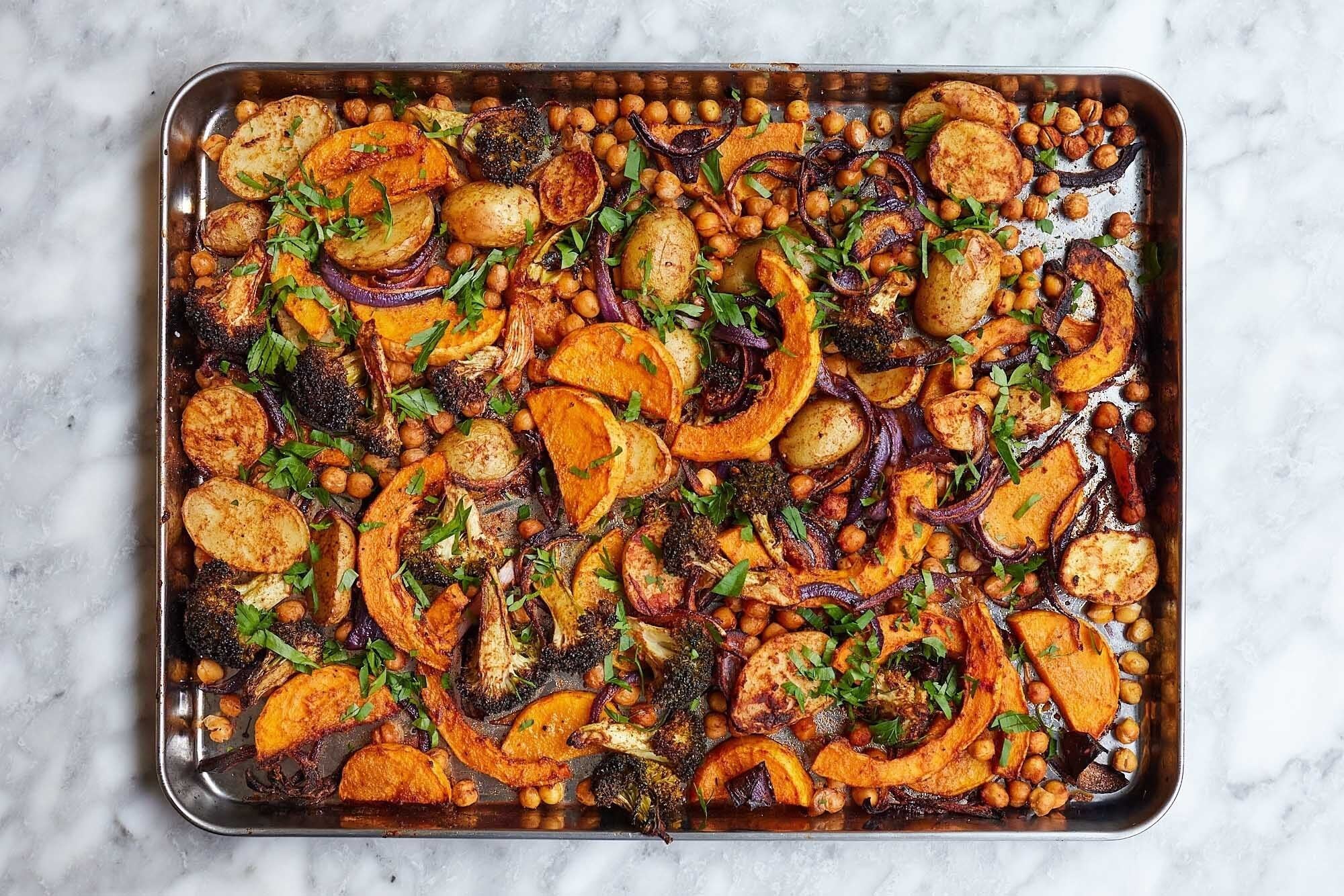 Roasted autumn vegetables with squash and chickpeas on a baking tray, a seasonal recipe by Ella