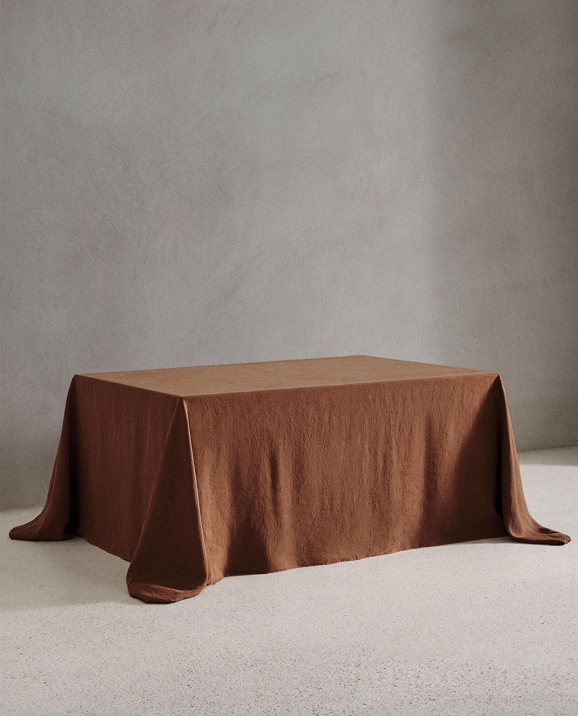 Chocolate brown linen tablecloth draped over a table, an autumn colour mood reference